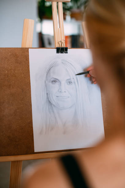 istock Painter Draws Woman Self-Portrait 1488533385