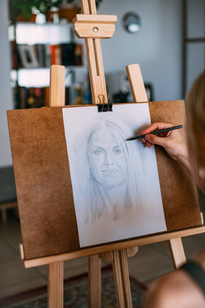istock Painter Draws Woman Self-Portrait 1488533482