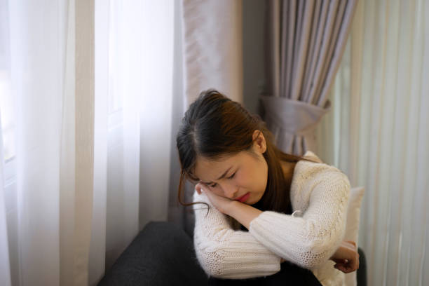 istock Pretty woman with sad emotion sit on sofa. 1488534523