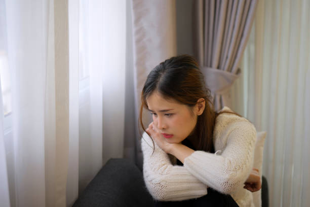 istock Pretty woman with sad emotion sit on sofa. 1488534543