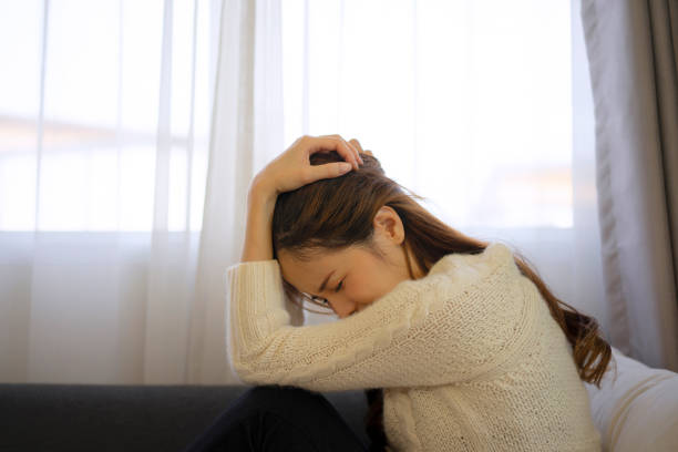 istock Pretty woman with sad emotion sit on sofa. 1488534558