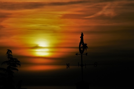 Weather Vane in silhouette at sunrise