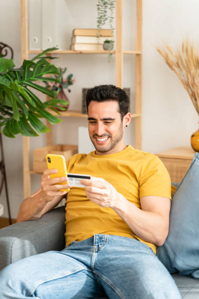 istock Young man with mobile phone checking his bank statement. 1488535409