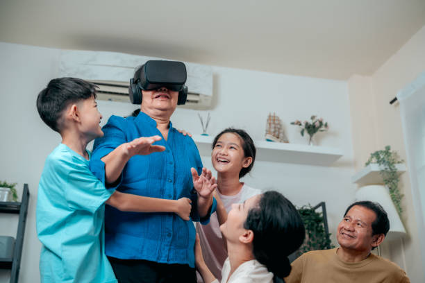 istock Grandmother having fun augmented reality Technology in VR headset at home with grandchild . virtual reality Metaverse World. 1488536828