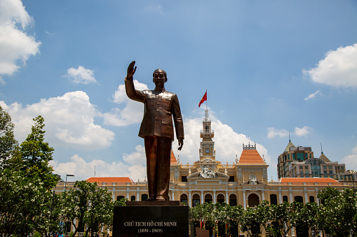 Ho Chi Minh Statue in front of People's Committee Building, the engraved text on the bottom base of the statue is the name and date of birth and death of Ho Chi Minh.