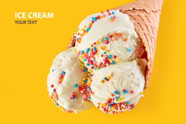 istock ice cream balls in a Waffle Cone on a Blue Background. Vanilla ice cream in a waffle cone. 1488539238