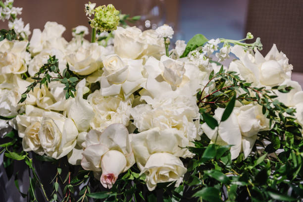 istock Delicate white roses flowers. Composition with copy space. Soft blurred flowers with soft bokeh in pastel tone for background. Closeup decor. Banner. Detail of decor in the interior on table. 1488539362