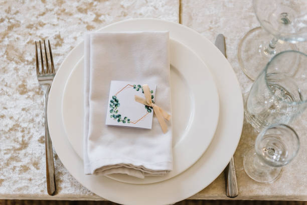istock Serving, setting table. Plate decorated linen napkin and silverware cutlery, knife and fork, glasses. flat lay. top view. Close up. Wedding set up, dinner table reception. Birthday, baptism and event. 1488539788