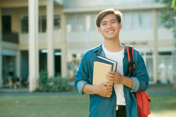 istock Student standing outdoor and holding books. 1488542146
