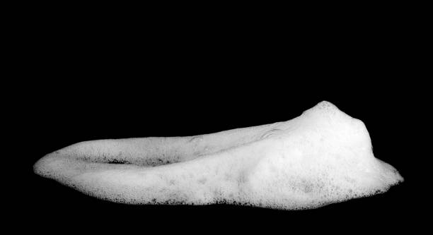 istock liquid white foam from soap or shampoo isolated on black background 1488542214