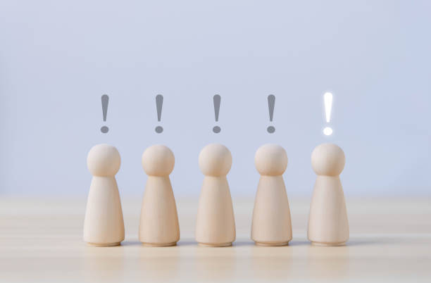 istock Block people showing a white exclamation mark. and different black 1488542236