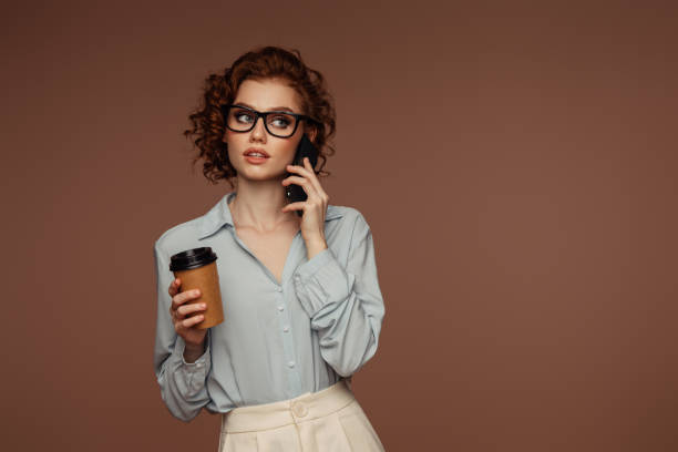 istock Beautiful emotional woman using phone and drinking coffee 1488544287