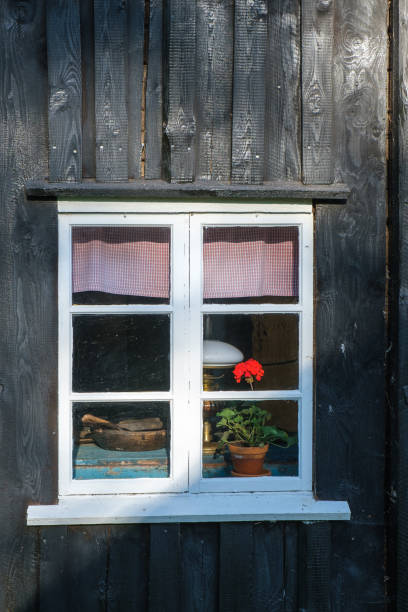 istock Window with a geranium flower in an old cottage 1488544625