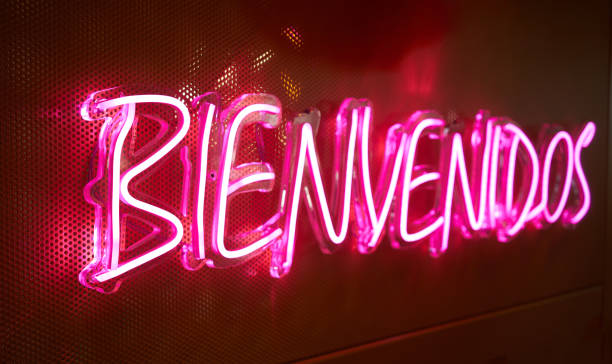 istock bright neon sign with the inscription welcome in spanish. 1488546242