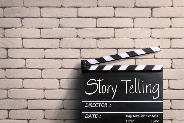 istock Storytelling  handwritten on clapperboard or film slate. white brick wall. 1488547922