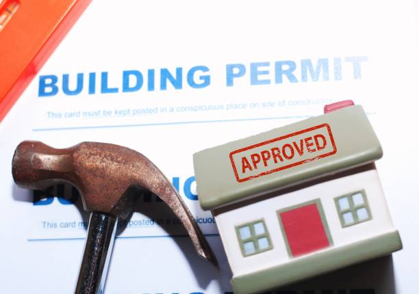 istock Building Permit concept with approved text on a residential home . 1488549785