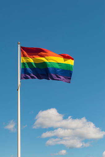 Pride flag and white clouds.