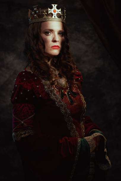 istock medieval queen in red dress with crown 1488553010