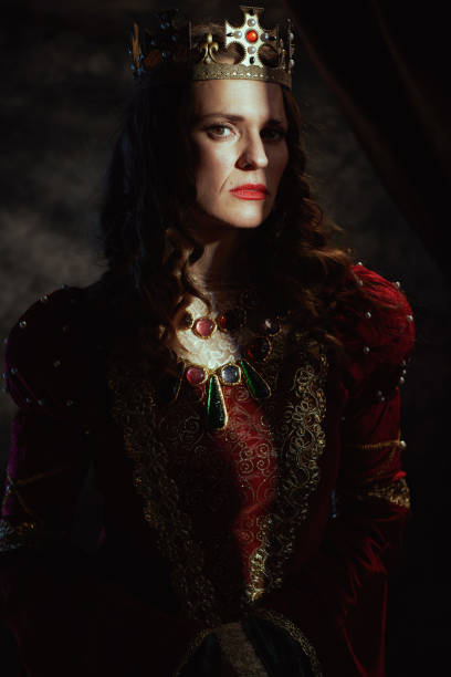 istock medieval queen in red dress with crown 1488553015