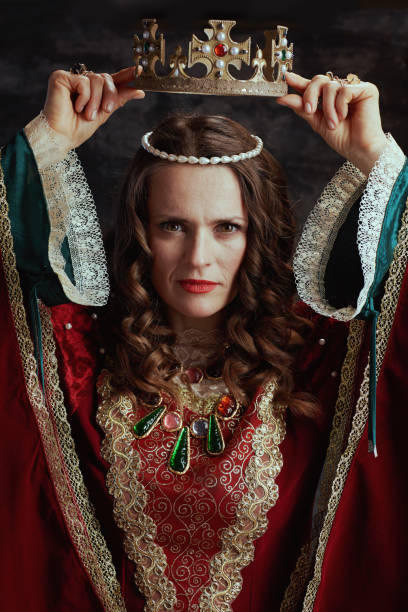 istock medieval queen in red dress with crown 1488553018