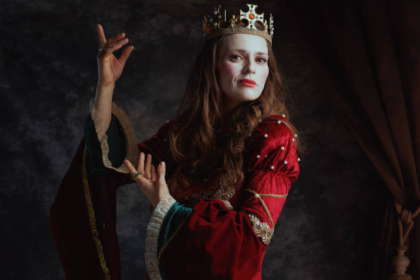 istock medieval queen in red dress with white makeup and crown 1488553028