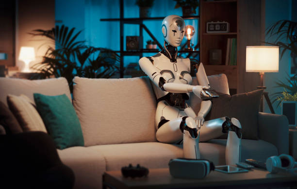 istock Humanoid robot sitting on the couch and watching TV 1488554523