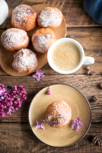 Coffee and donuts on wooden table. Top view with space for your text