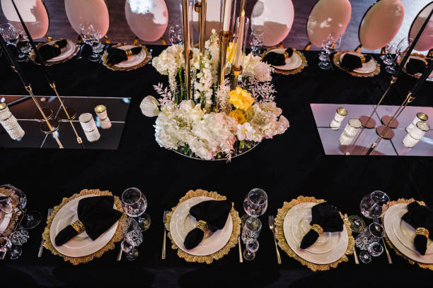 istock Luxury golden rich decor. Plate decorated napkin, cutlery, glasses. Serving, setting table. Wedding set up, dinner reception. Birthday, baptism, event. Festive tables with flowers, candles. Top view. 1488557475