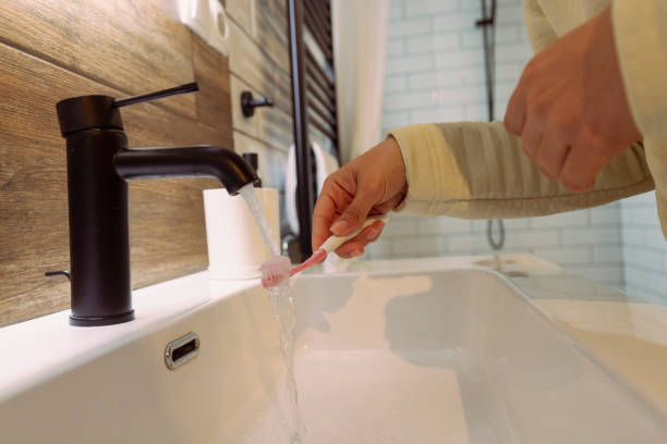 istock Toothpaste on a toothbrush at the bathroom sink 1488558885