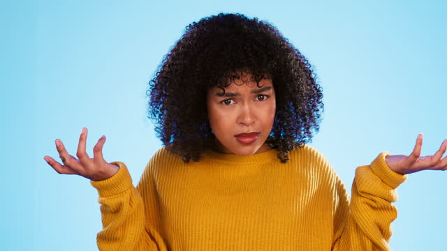 Face, confused and unsure black woman in studio, pensive and dont know gesture on blue background. Doubt, portrait and girl with decision, why or emoji on mockup, puzzled or posing indoors isolated