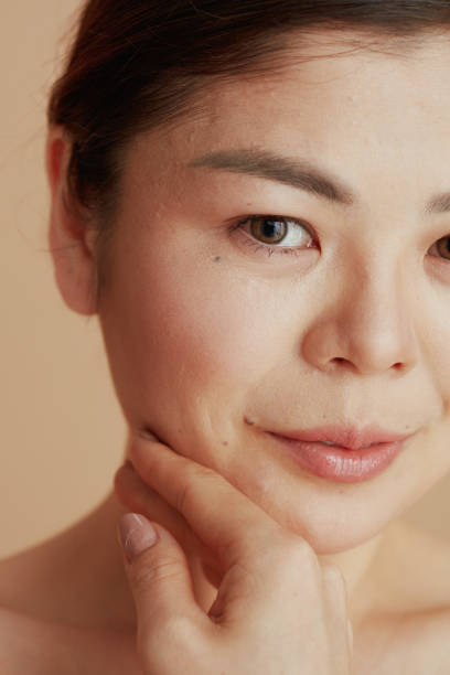 istock Closeup on woman looking in camera on beige background 1488562058