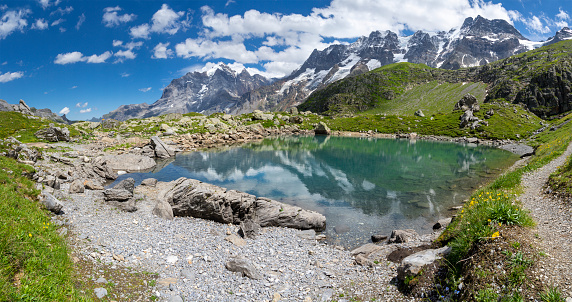 The panorma of Oberhornsee lake with the Jungfrau, Mittaghorn and Grosshorn peaks.