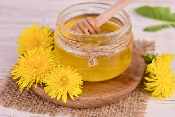 istock Fresh honey from spring dandelions in a jar. Close-up. 1488564060