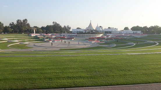 view from finish line with checkered flag waving at the race track.