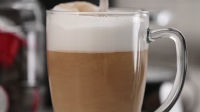 Coffee cappuccino mixing in transparent cup