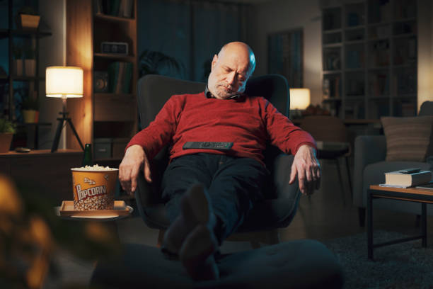 istock Senior man falling asleep in front of the TV 1488569192