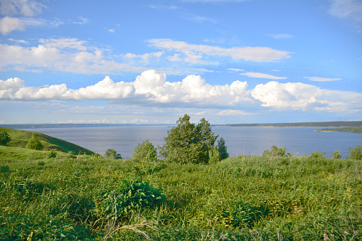 A view of the lake with cloudscape and the horizon line in the distance, copy space