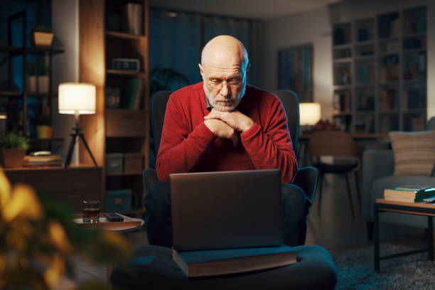 istock Senior man using a laptop at home 1488570041