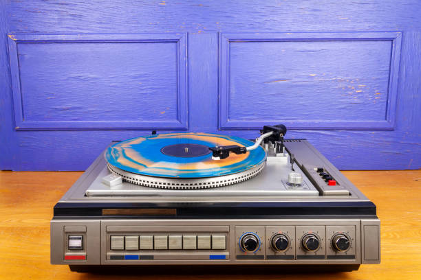 istock Vintage turntable vinyl record player with blue and orange vinyl 1488574203
