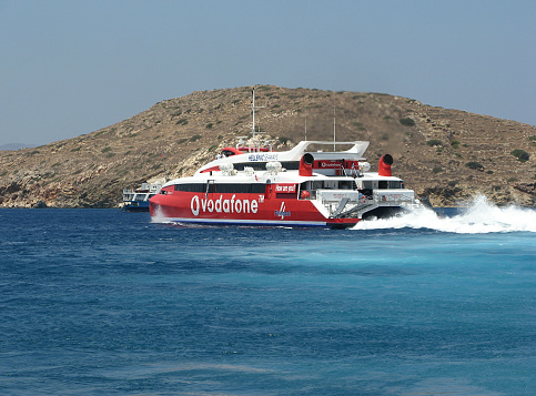 Island of Ios, Cyclades, Greece - July 16, 2006: Hellenic Seaways passenger catamaran Flying Cat 4 leaving the port bay of Ios island