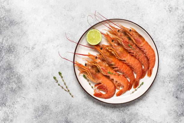 istock Large red langoustines in a plate on a light grunge background. Top view, flat lay. 1488579263