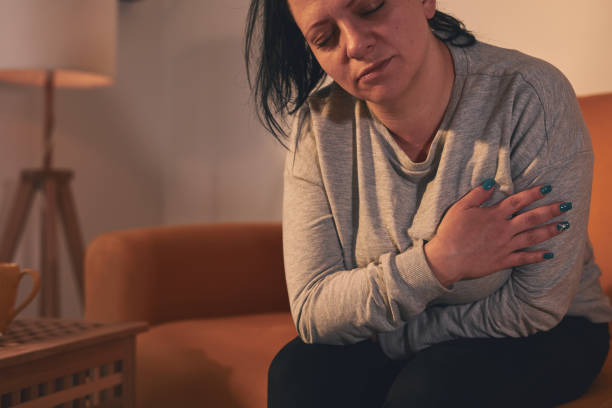 istock Woman with strong stomach ache and digestive issues at home. 1488580034