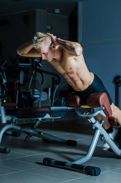 istock Attractive and fit young man in gym working out legs 1488580923