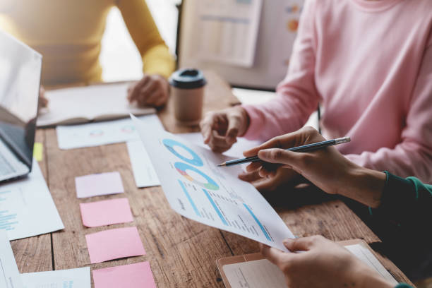 istock Business people meeting explaining the financial graph data and marketing plan. Group of business people at meeting assessment the state of business investment and marketing. 1488591621