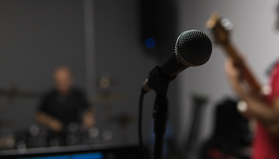 close up of a microphone in a rehesal of a metal band