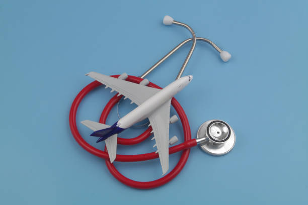 istock Airplane with red stethoscope on blue background. 1488596091