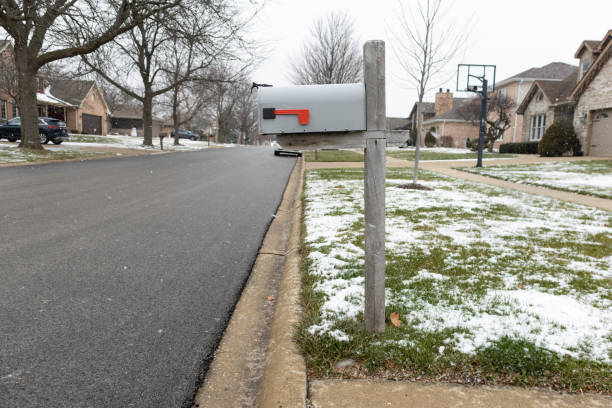 istock Basic Mailbox along a Neighborhood Residential Street with Homes during a Light Snowfall in Winter in Lemont Illinois 1488597507