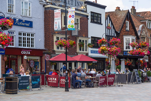 Salisbury, Wiltshire, UK, July 20, 2017; People enjoy the terraces of the restaurants and pubs in the market square in the historic city of Salisbury.