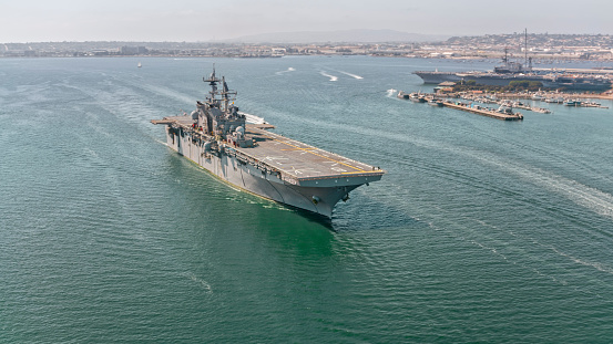 Aerial view of naval ship travelling in San Diego Bay, San Diego, California, USA.