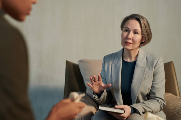istock Mature female psychotherapist comforting patient during session 1488601827